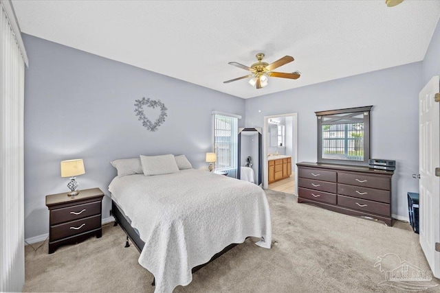 5761 Twisted Oak Ct, Pace, FL 32571 - bedroom with light carpet, connected bathroom, baseboards, and a ceiling fan