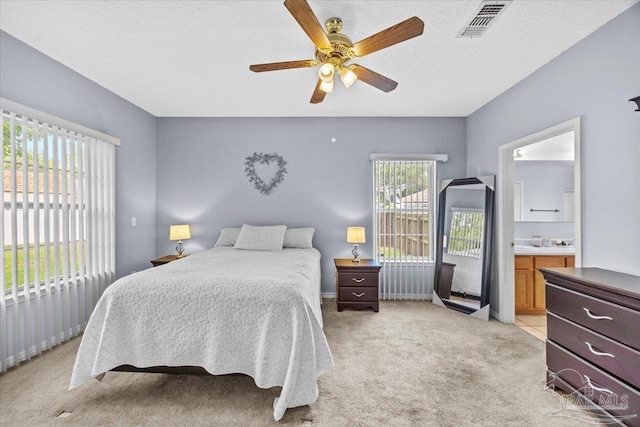 5761 Twisted Oak Ct, Pace, FL 32571 - bedroom with access to exterior, visible vents, ceiling fan, light colored carpet, and ensuite bath