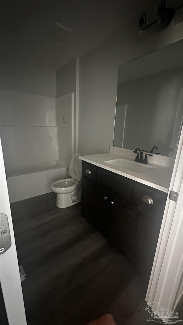 6280 Long St, Milton, FL 32570 - bathroom featuring wood finished floors, vanity, and washtub / shower combination