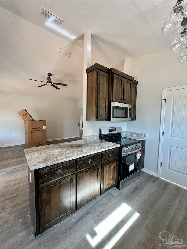 6280 Long St, Milton, FL 32570 - kitchen with stainless steel appliances, wood finished floors, dark brown cabinets, and light stone countertops