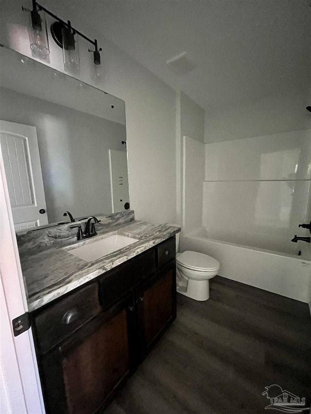 6280 Long St, Milton, FL 32570 - bathroom featuring wood finished floors, vanity, and shower / tub combination