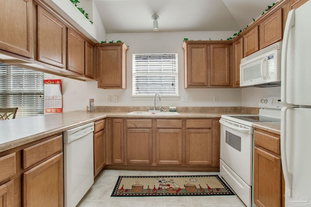 1408 Dunhurst Dr, Pensacola, FL 32534 - kitchen with brown cabinets, a sink, white appliances, light countertops, and vaulted ceiling