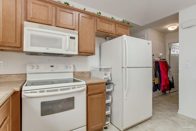 1408 Dunhurst Dr, Pensacola, FL 32534 - kitchen featuring white appliances, brown cabinetry, and light countertops
