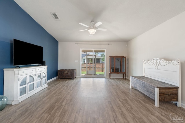 unfurnished living room featuring ceiling fan, baseboards, wood finished floors, and visible vents