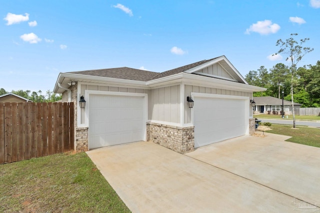 exterior space featuring concrete driveway, fence, an attached garage, a shingled roof, and board and batten siding