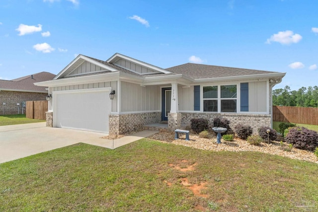 view of front of home featuring fence, an attached garage, driveway, stone siding, and a front yard