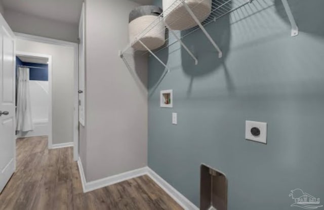 washroom featuring baseboards, dark wood-type flooring, and laundry area