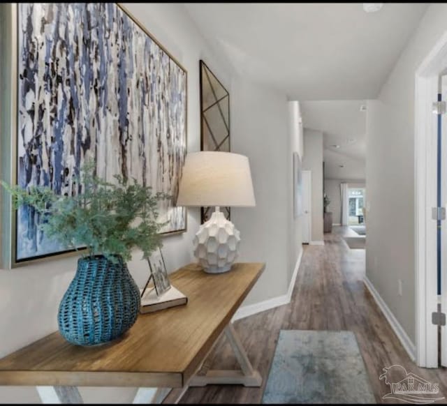 hall with wood finished floors and baseboards