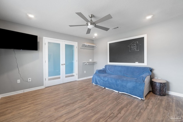 sitting room with wood finished floors, visible vents, a ceiling fan, french doors, and baseboards