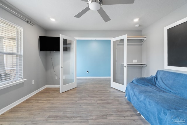 sitting room featuring french doors, baseboards, recessed lighting, wood finished floors, and ceiling fan