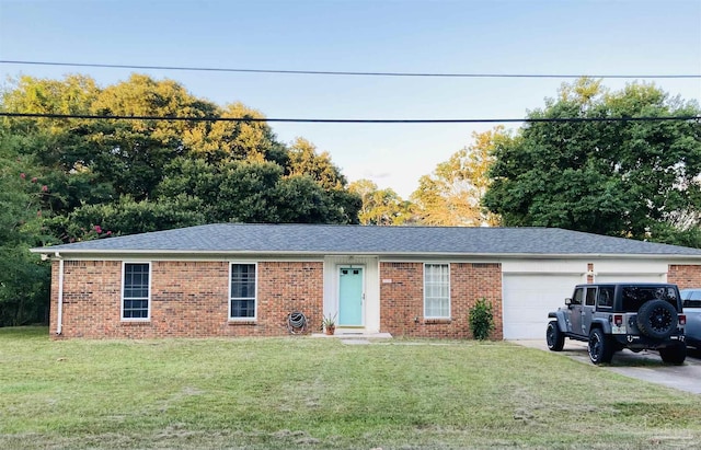 ranch-style home featuring a garage and a front lawn