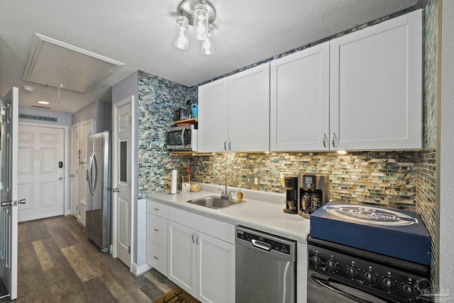 kitchen featuring stainless steel appliances, white cabinetry, dark hardwood / wood-style floors, and decorative backsplash