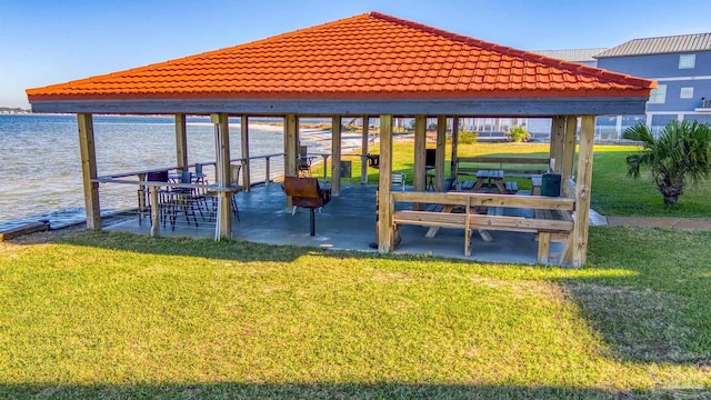 view of dock featuring a yard, a gazebo, and a water view