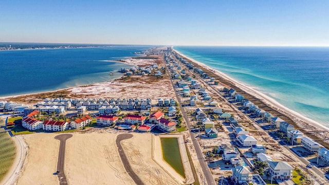 birds eye view of property featuring a view of the beach and a water view