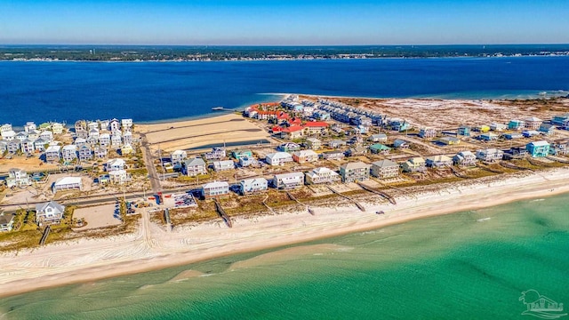 drone / aerial view featuring a water view and a beach view