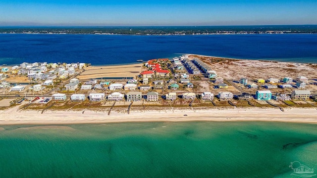 birds eye view of property with a water view and a view of the beach