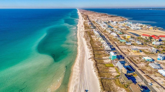 drone / aerial view with a water view and a view of the beach