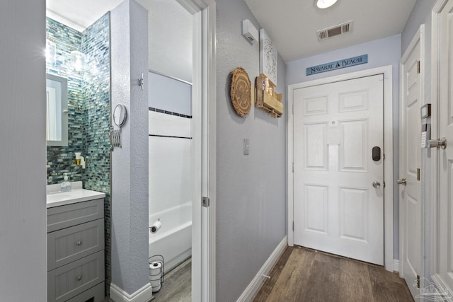 doorway with wood-type flooring