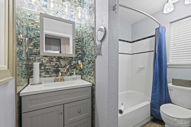 full bathroom with vanity, shower / tub combo, and toilet