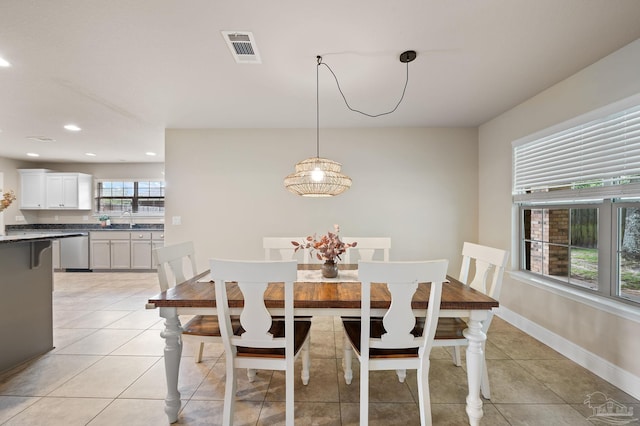 tiled dining area featuring sink