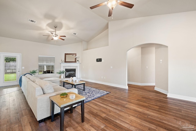 living room with ceiling fan, dark hardwood / wood-style floors, and high vaulted ceiling