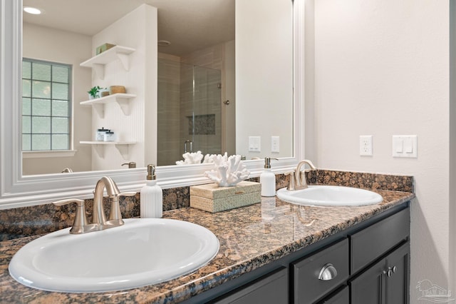 bathroom featuring vanity and a shower with door