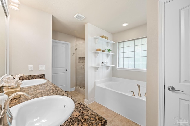 bathroom with plus walk in shower, tile patterned floors, and vanity