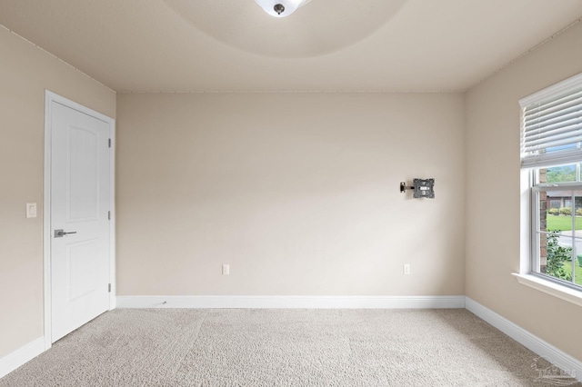 carpeted spare room featuring a wealth of natural light