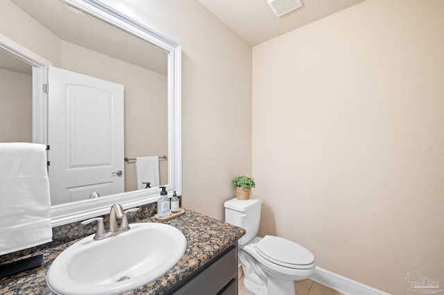 bathroom with tile patterned floors, vanity, and toilet