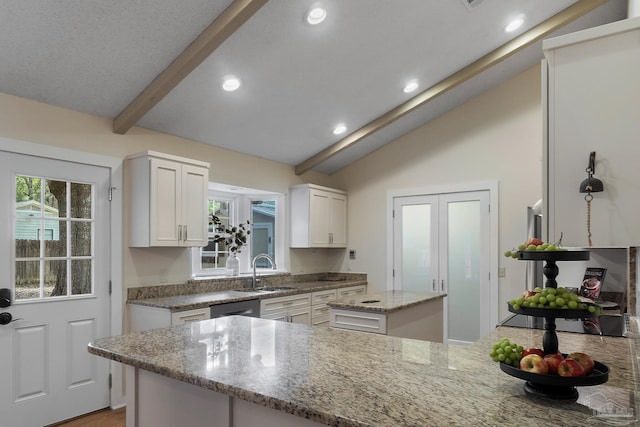 4507 Whisper Way, Pensacola, FL 32504 - kitchen featuring white cabinets, light stone countertops, a kitchen island, recessed lighting, and a peninsula
