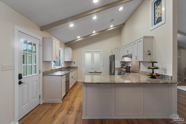 4507 Whisper Way, Pensacola, FL 32504 - kitchen with appliances with stainless steel finishes, stone counters, a peninsula, light wood-type flooring, and recessed lighting