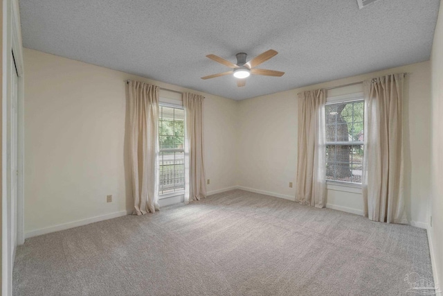 4507 Whisper Way, Pensacola, FL 32504 - unfurnished room with plenty of natural light, a ceiling fan, carpet, and a textured ceiling