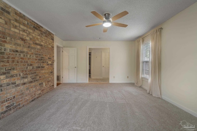 4507 Whisper Way, Pensacola, FL 32504 - unfurnished bedroom with a textured ceiling, brick wall, a ceiling fan, and carpet floors