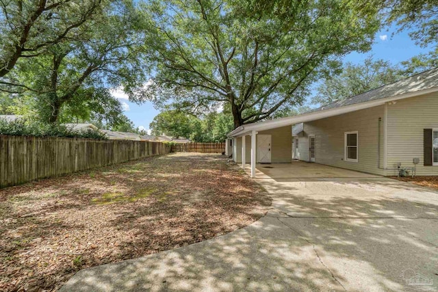 4507 Whisper Way, Pensacola, FL 32504 - fenced backyard with a carport and concrete driveway