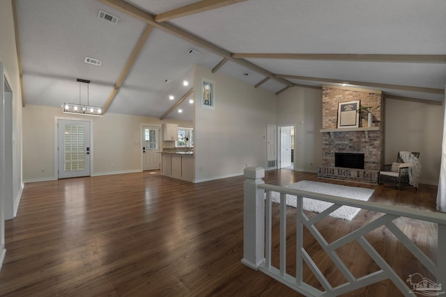 4507 Whisper Way, Pensacola, FL 32504 - living room with a fireplace, dark wood-type flooring, beam ceiling, high vaulted ceiling, and a chandelier