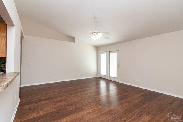 unfurnished living room with vaulted ceiling, dark hardwood / wood-style flooring, and ceiling fan