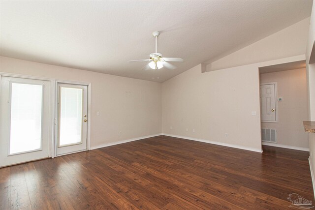 spare room with a textured ceiling, ceiling fan, vaulted ceiling, and dark hardwood / wood-style flooring