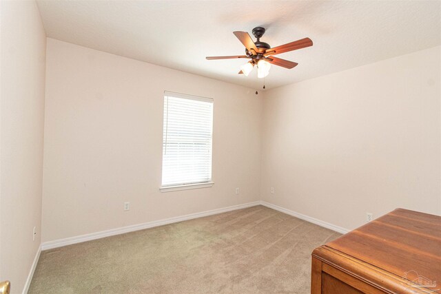 carpeted empty room featuring ceiling fan