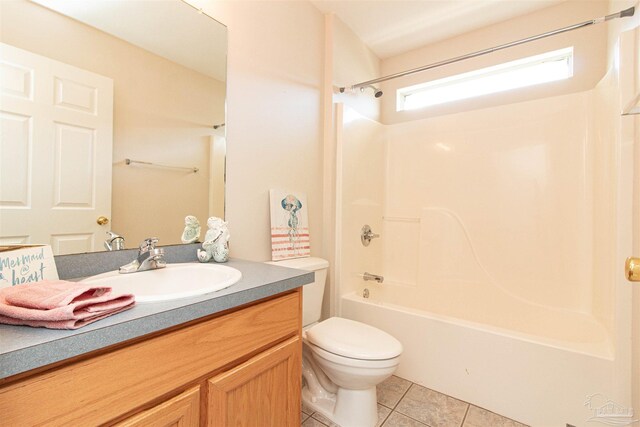 full bathroom featuring vanity, tile patterned flooring, toilet, and washtub / shower combination