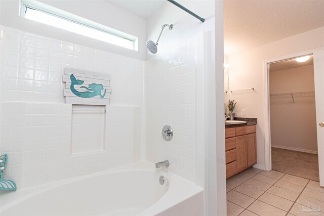 bathroom with shower / bath combination, tile patterned floors, vanity, and a textured ceiling