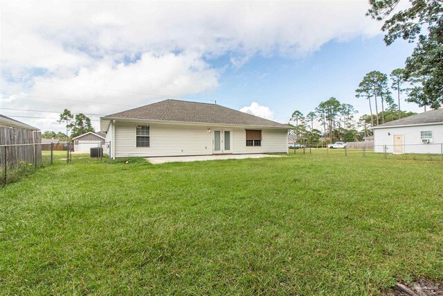 rear view of property with a yard, a patio area, and central air condition unit