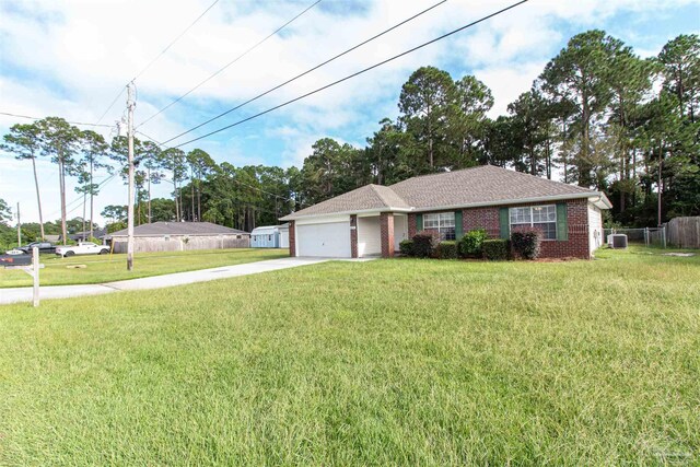 ranch-style home featuring a garage, central AC, and a front lawn