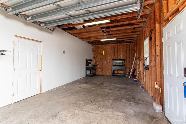 garage featuring wooden walls