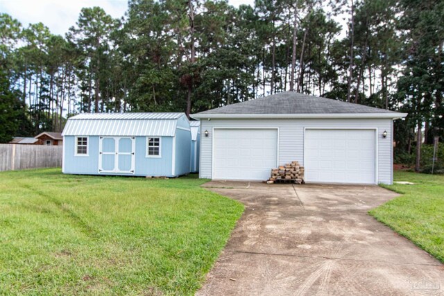 view of front facade with a storage unit, a front yard, and a garage