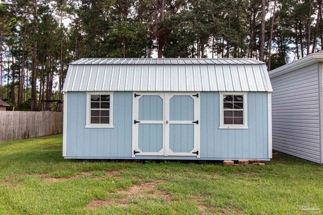 view of outbuilding with a yard