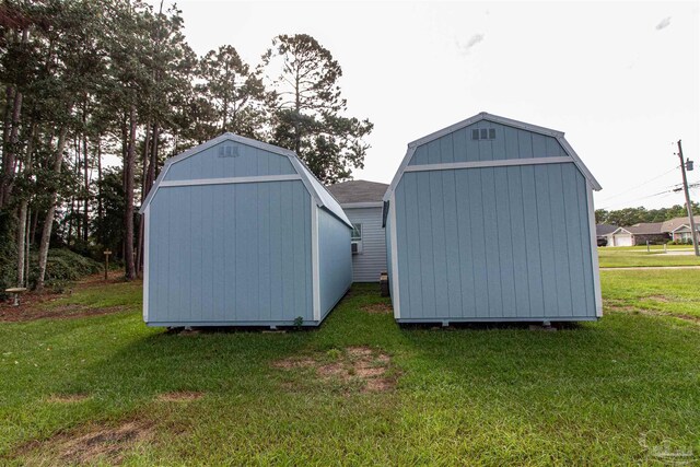 view of outbuilding featuring a lawn