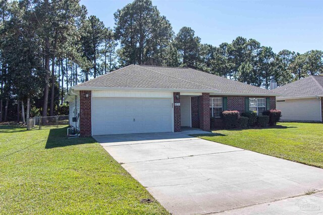 ranch-style house with a garage and a front yard