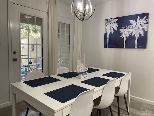 dining space featuring hardwood / wood-style floors and a notable chandelier