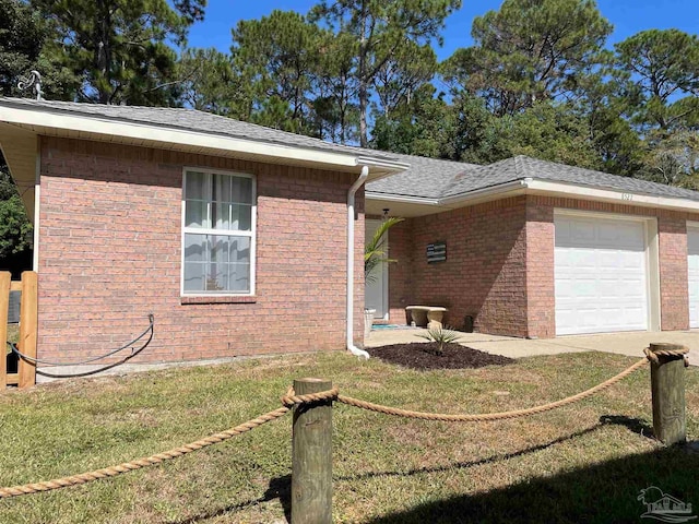 view of side of home with a garage and a yard