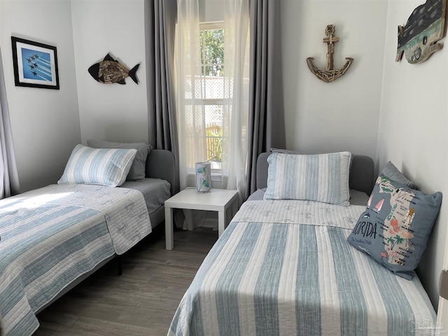 bedroom with dark hardwood / wood-style flooring